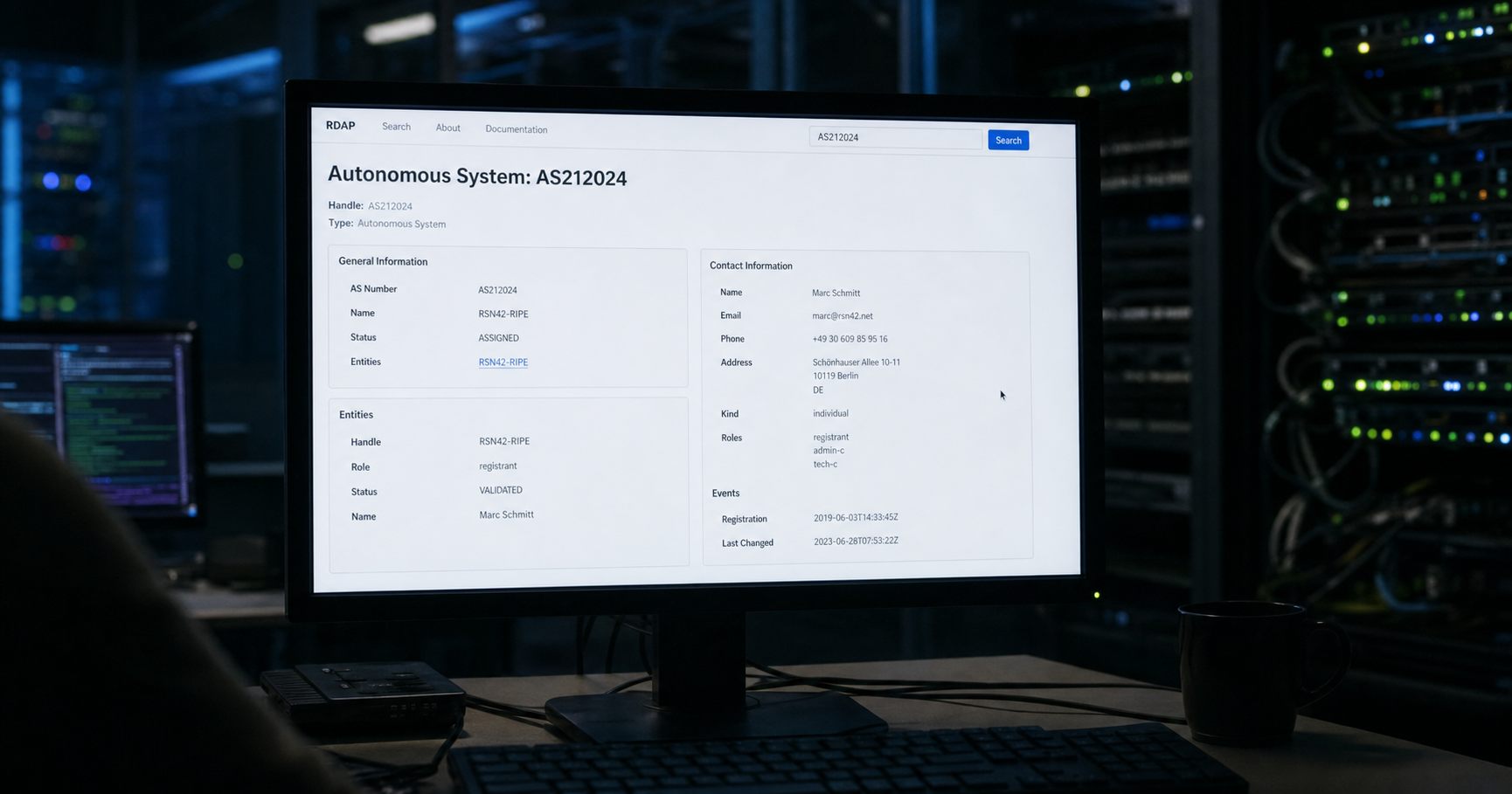 A dim network operations center with a monitor displaying an RDAP query for AS212024 showing the handle RSN42-RIPE and contact details for Marc Schmitt.