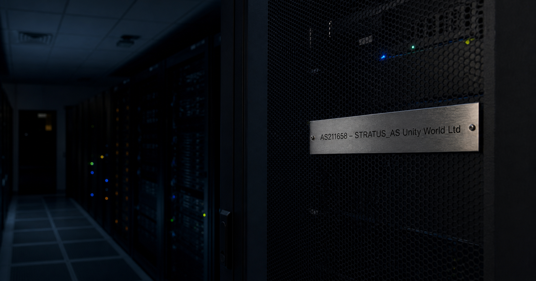 A dark, quiet network operations center with a server rack labeled AS211658 – STRATUS_AS Unity World Ltd, all indicator lights off, and a monitor showing 'no route announcements' in red.