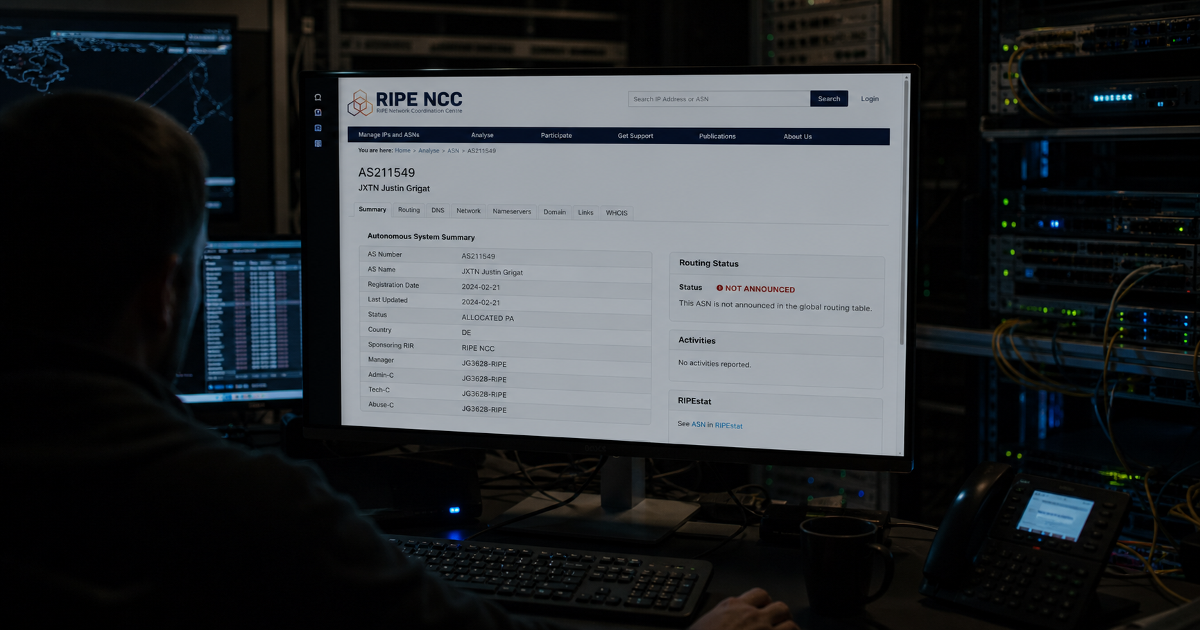 A dimly lit network operations center with a single monitor displaying an RDAP record for AS211549.