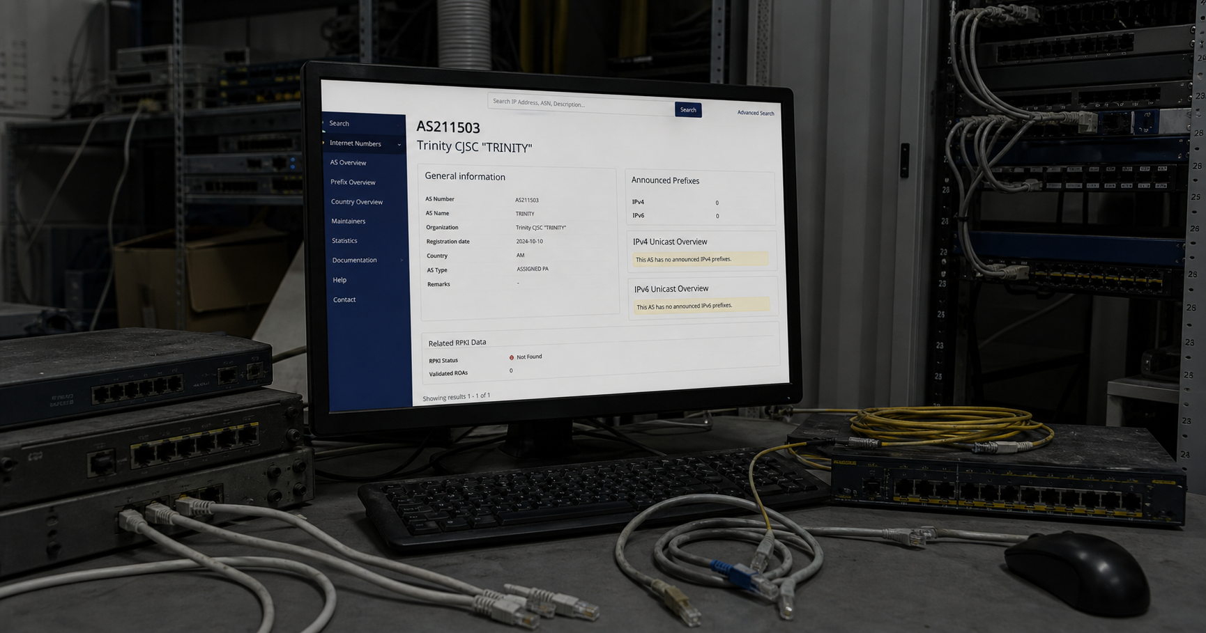 A dimly lit network operations center with a single monitor displaying a RIPE NCC ASN registration page for AS211503, showing the name 'Trinity CJSC "TRINITY"' and zero prefixes, surrounded by unplugged network cables and dusty equipment, evoking a sense of potential but currently inactive routing capability.