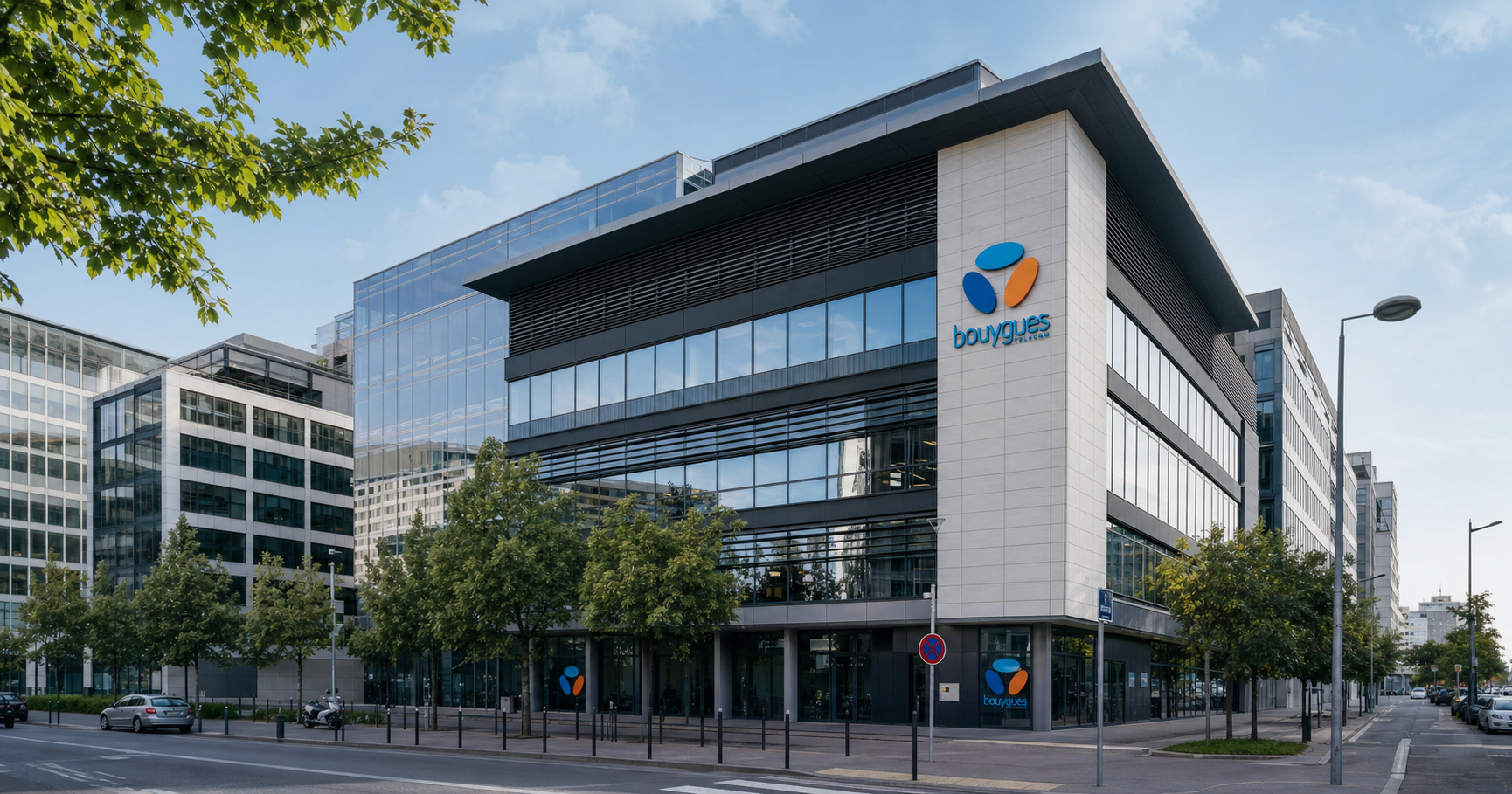 Exterior of a Bouygues Telecom office building in France with the company logo visible.