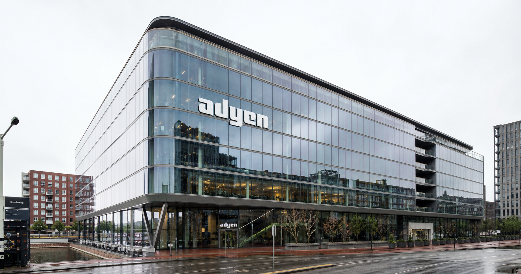 Corporate office building with Adyen branding, symbolizing the company’s established presence in global financial technology and its underlying network infrastructure.