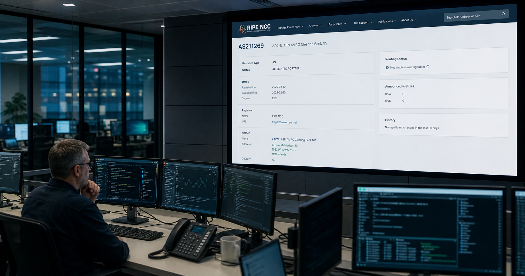 A network operations room with a large screen displaying ABN AMRO Clearing Bank's AS211269 registry entry.