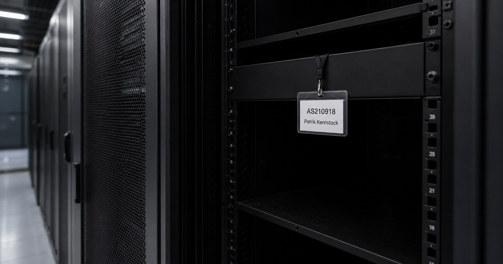 A dim, quiet data center aisle with an open rack cabinet containing a laminated card marked 'AS210918' and 'Patrik Kernstock', a dangling network cable, and a shadowy figure holding a key fob.