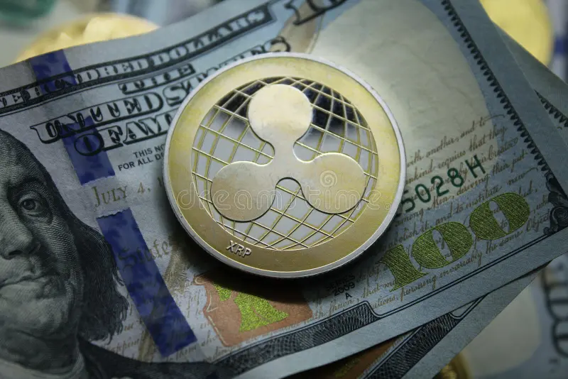 ripple-xrp-cryptocurrency-golden-coin-lying-hundred-dollars-bills-background-electronic-money-exchange-concept-photo-156141278