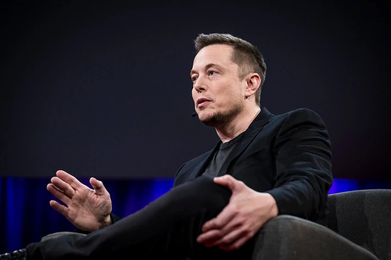 Person-sitting-making-a-subtle-hand-gesture