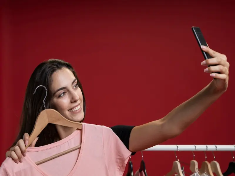 A woman is selling clothes.